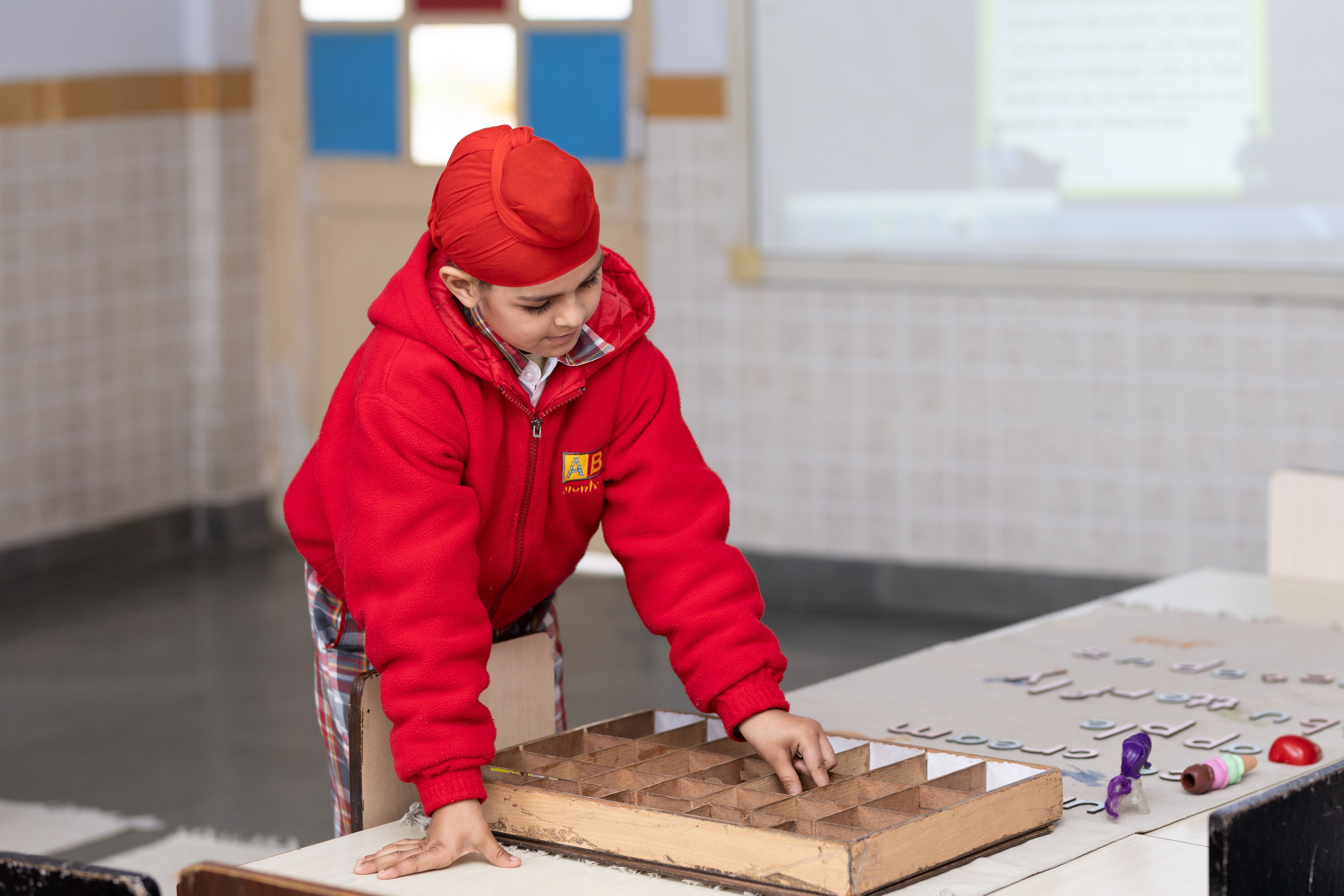 Boy playing a board game at school as part of a life skills enrichment activity
